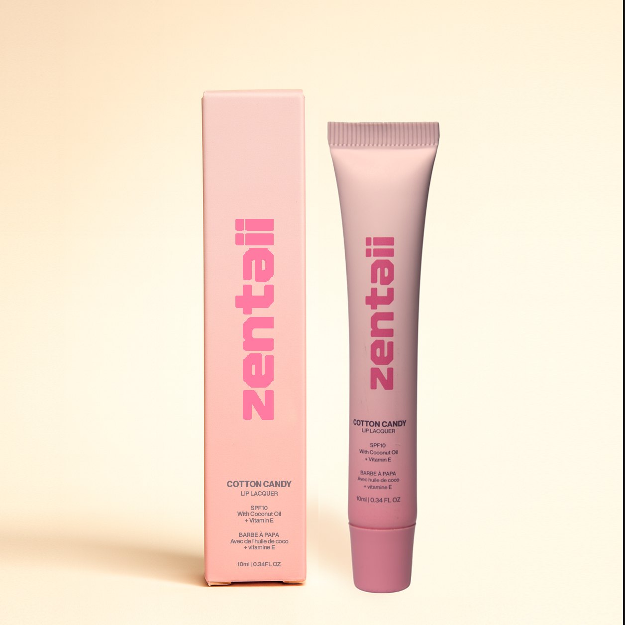 A pink lip carton beside its soft tube applicator.